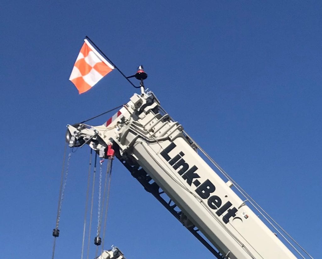 Orange and white checkered flag on a crane